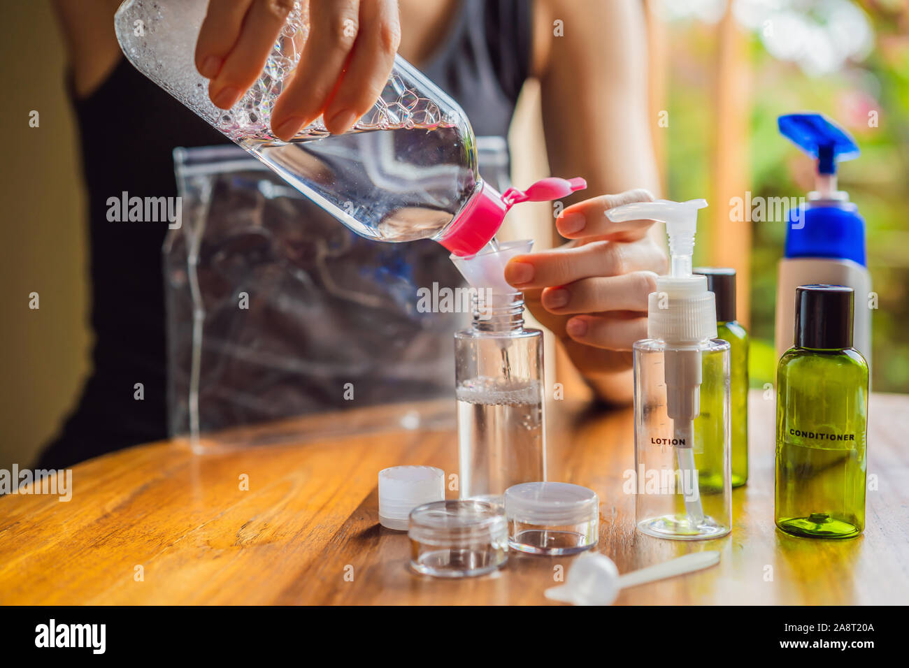 Travel kit for transporting cosmetics on an airplane. Cosmetics are ready  to be poured into small bottles. A woman shifts cosmetics to take with her  Stock Photo - Alamy