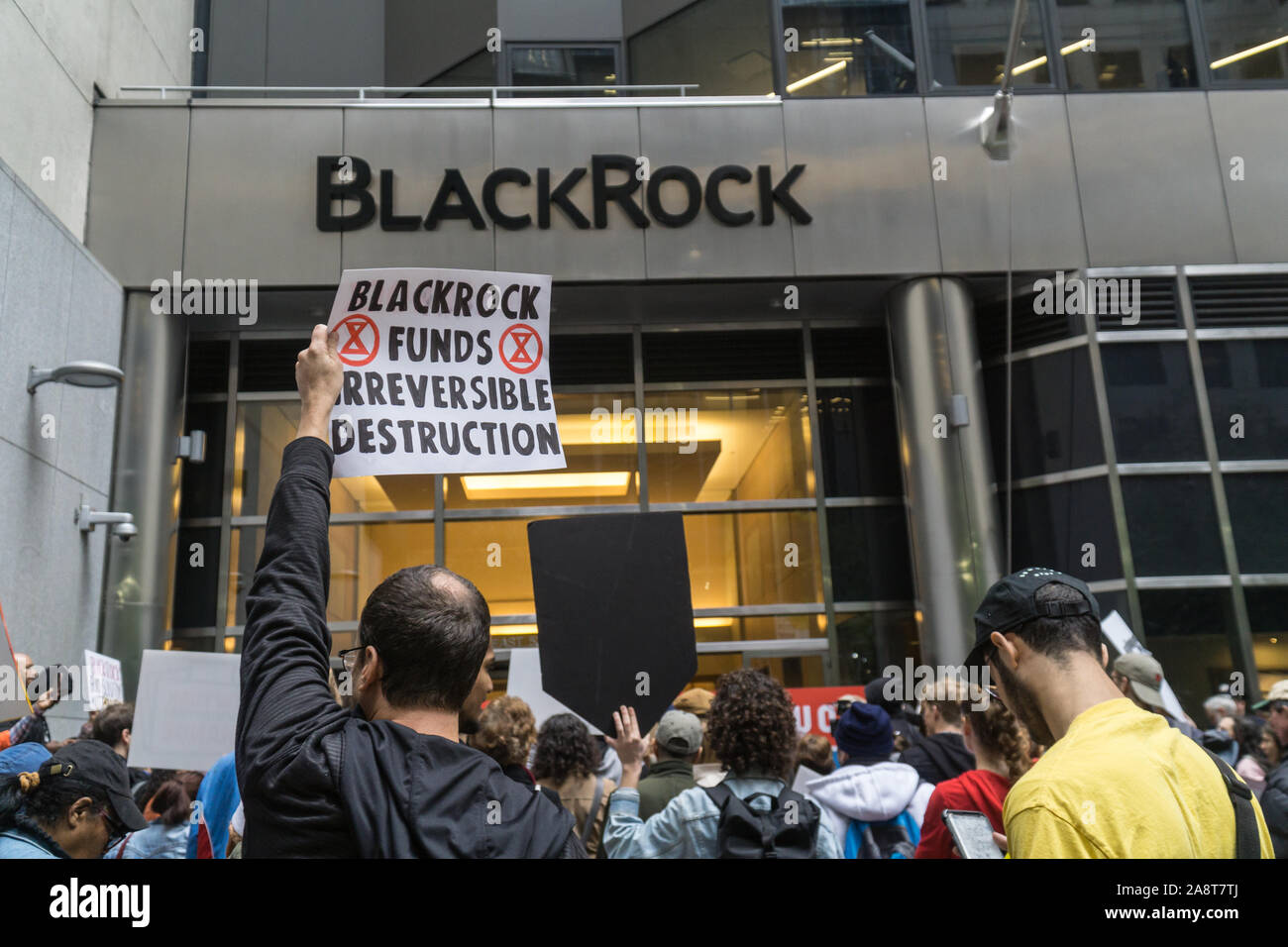 Climate justice activists protest in front of BlackRock office in New York City and demand CEO Larry Fink to stop funding fossil fuel companies. Stock Photo
