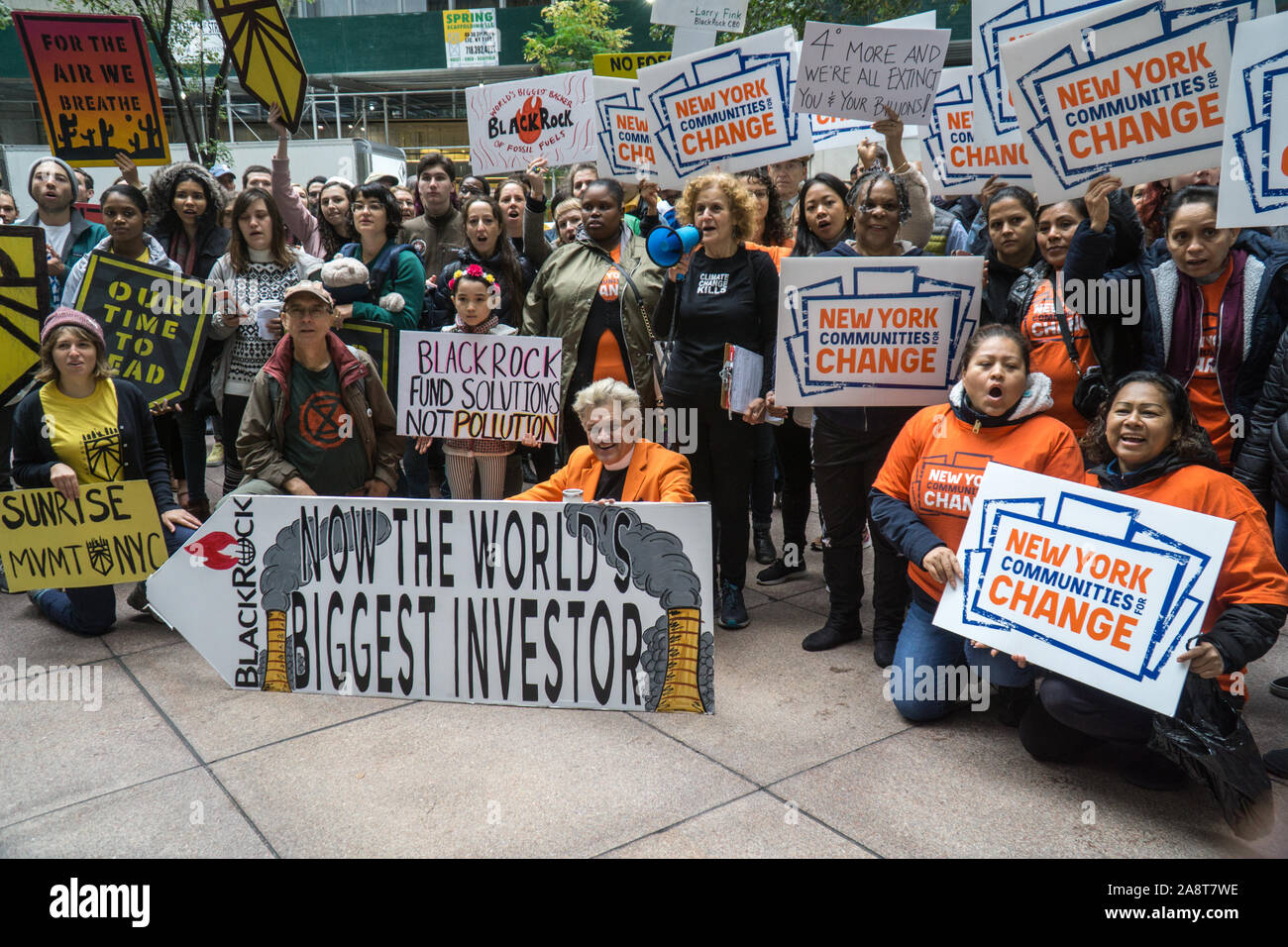 Climate justice activists protest in front of BlackRock office in New York City and demand CEO Larry Fink to stop funding fossil fuel companies. Stock Photo
