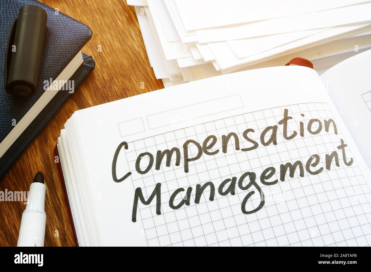 Compensation management concept. Book and papers in the office Stock