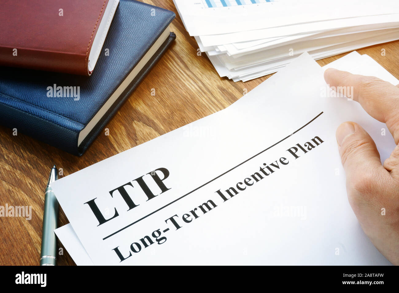 Long-Term Incentive Plan LTIP holds by man. Stock Photo