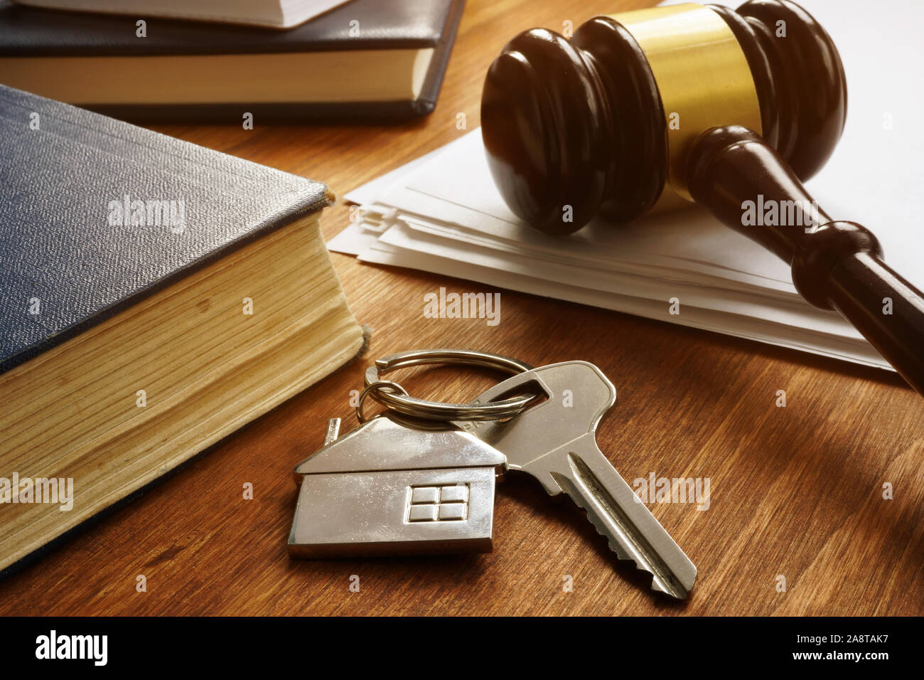 Property law concept. Key from real estate and gavel. Stock Photo