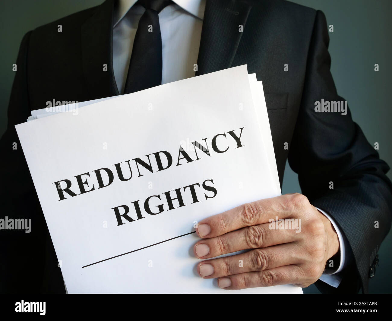 Man is holding Redundancy rights law. Stock Photo