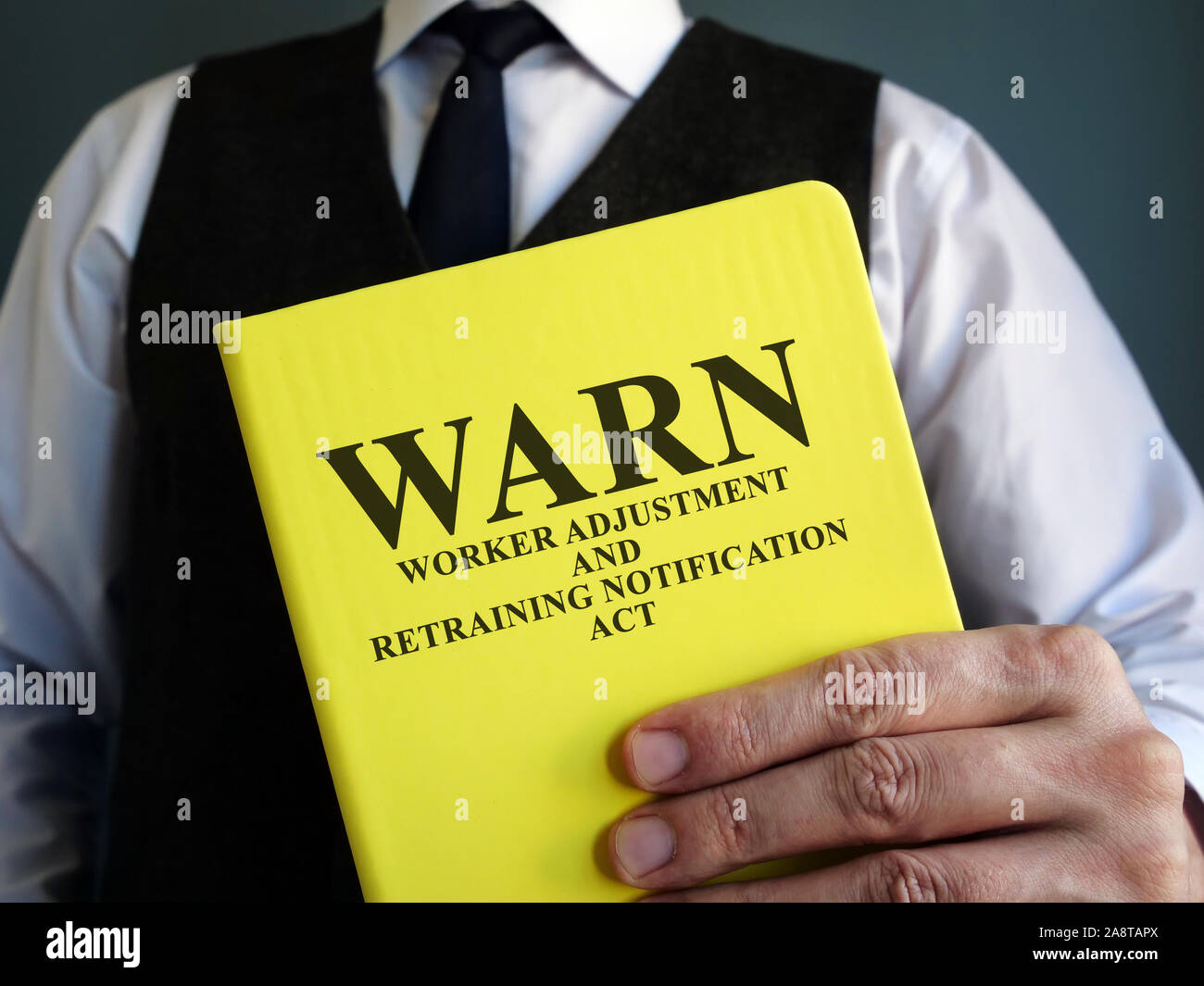 Man holds Worker Adjustment and Retraining Notification Act WARN. Stock Photo