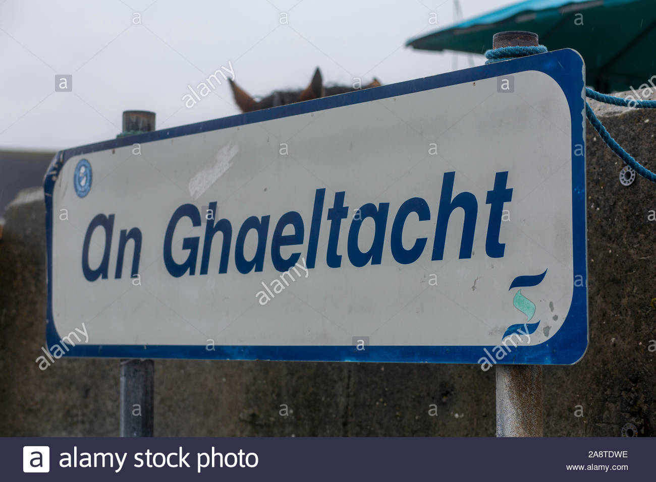 A blue Gaeltacht sign on the island of Inisheern near Galway showing that the area is an Irish-speaking area. Stock Photo