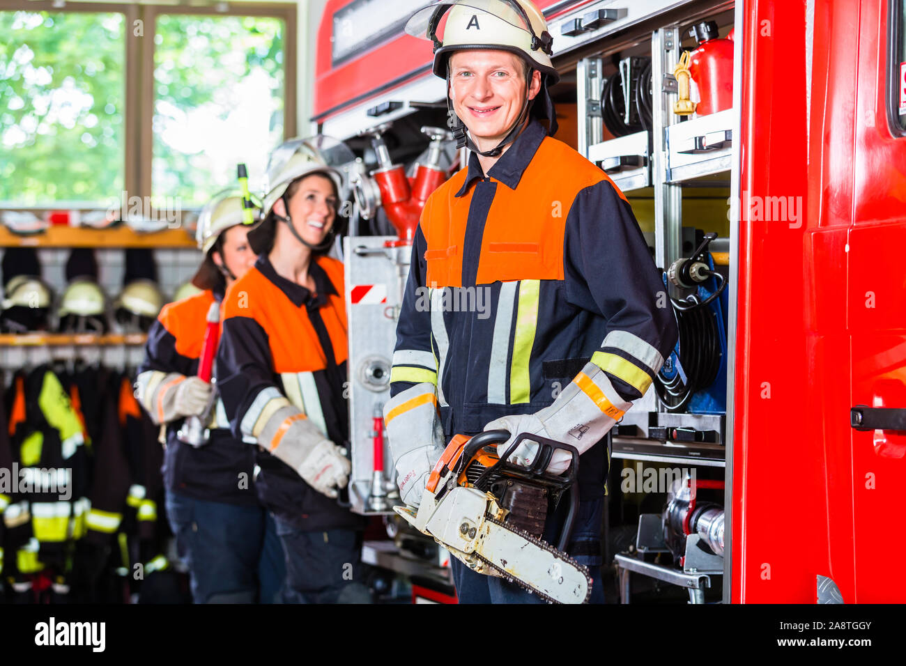 Fire fighters attaching hose at hose laying vehicle Stock Photo - Alamy