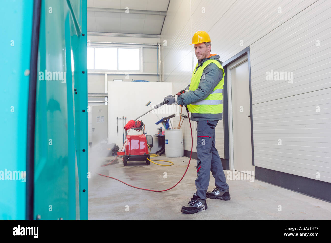 Worker cleaning a rental or mobile toilet Stock Photo