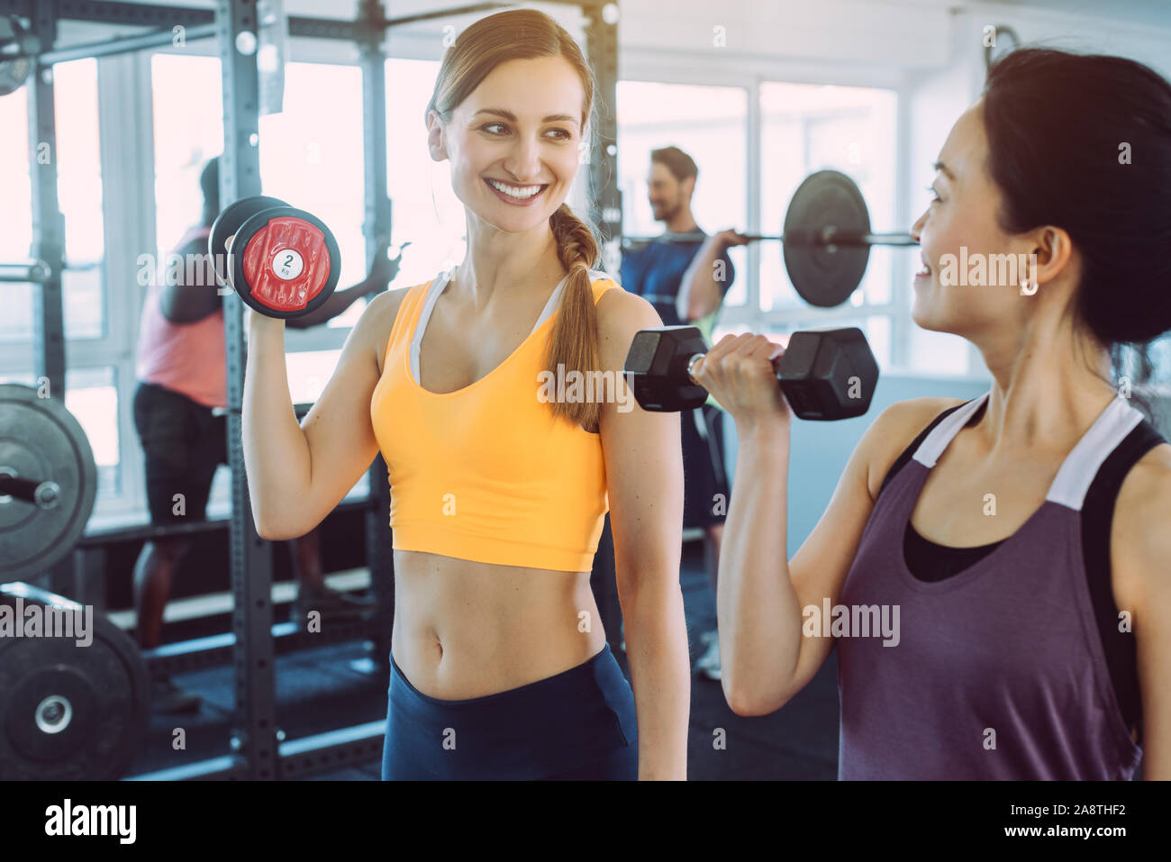 Two women doing fitness training together in the gym Stock Photo