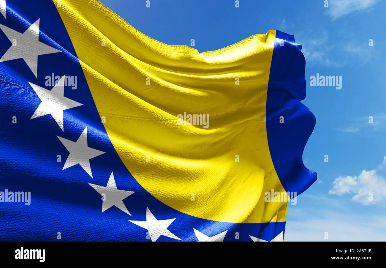 Bosnia and Herzegovina flag is waving against blue sky with clouds ...