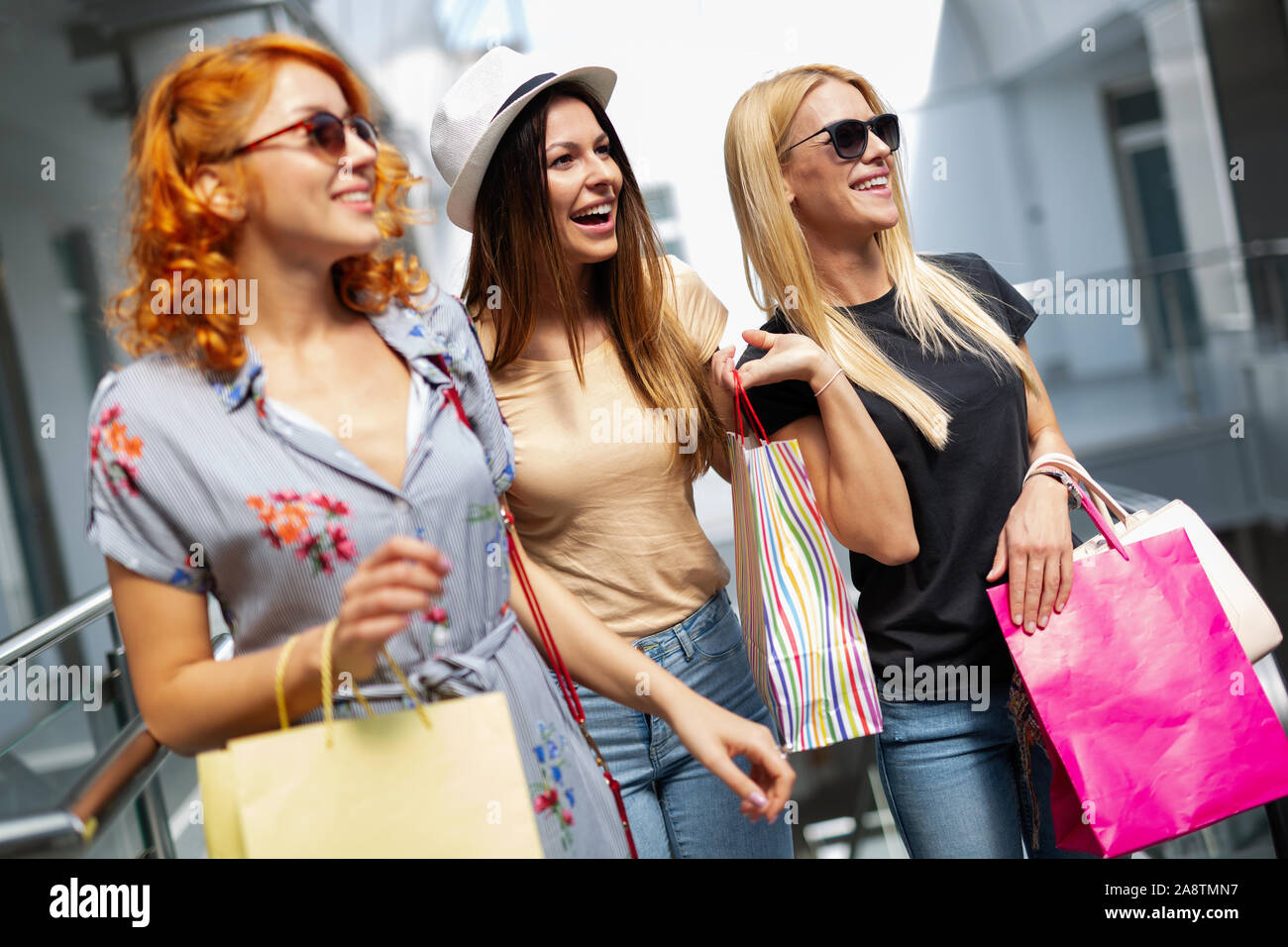 Beautiful women with shopping bags walking at the mall Stock Photo - Alamy