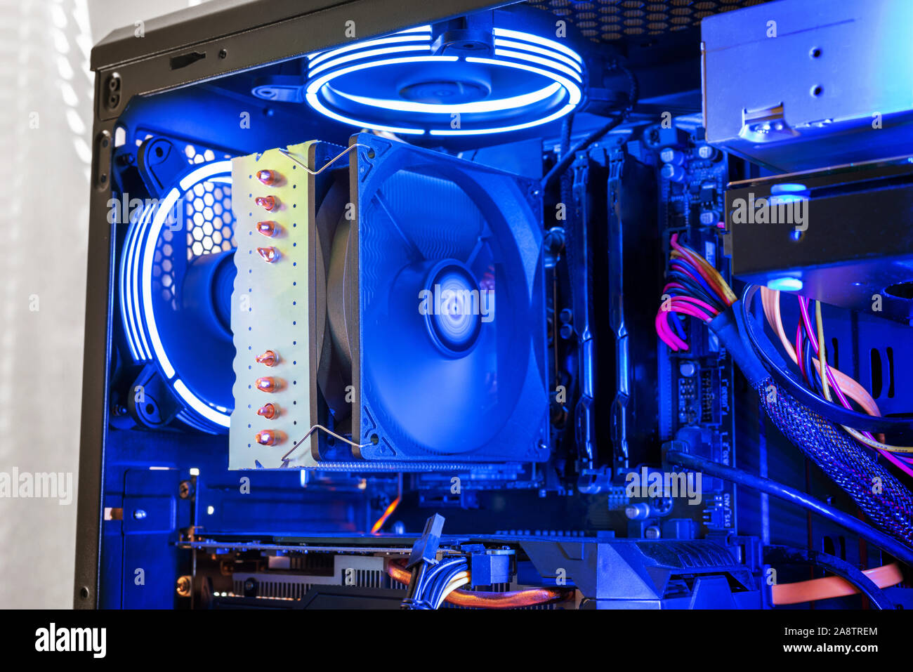 Large processor cooler on a modern gaming computer with RGB illumination. Detail of processor, memory, graphics card and coolers. Stock Photo