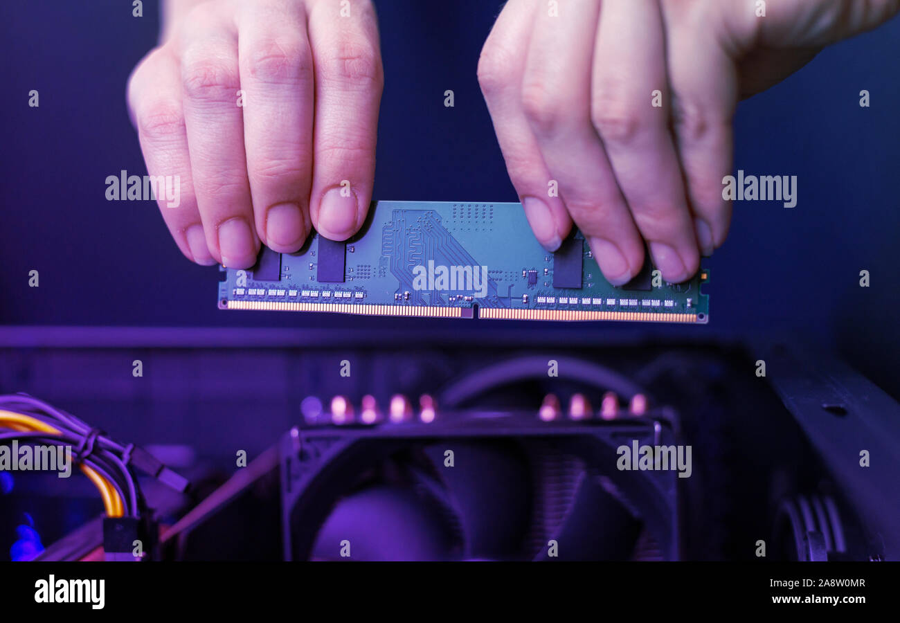 Installing a memory module in your computer. A simple module for a personal computer. Stock Photo