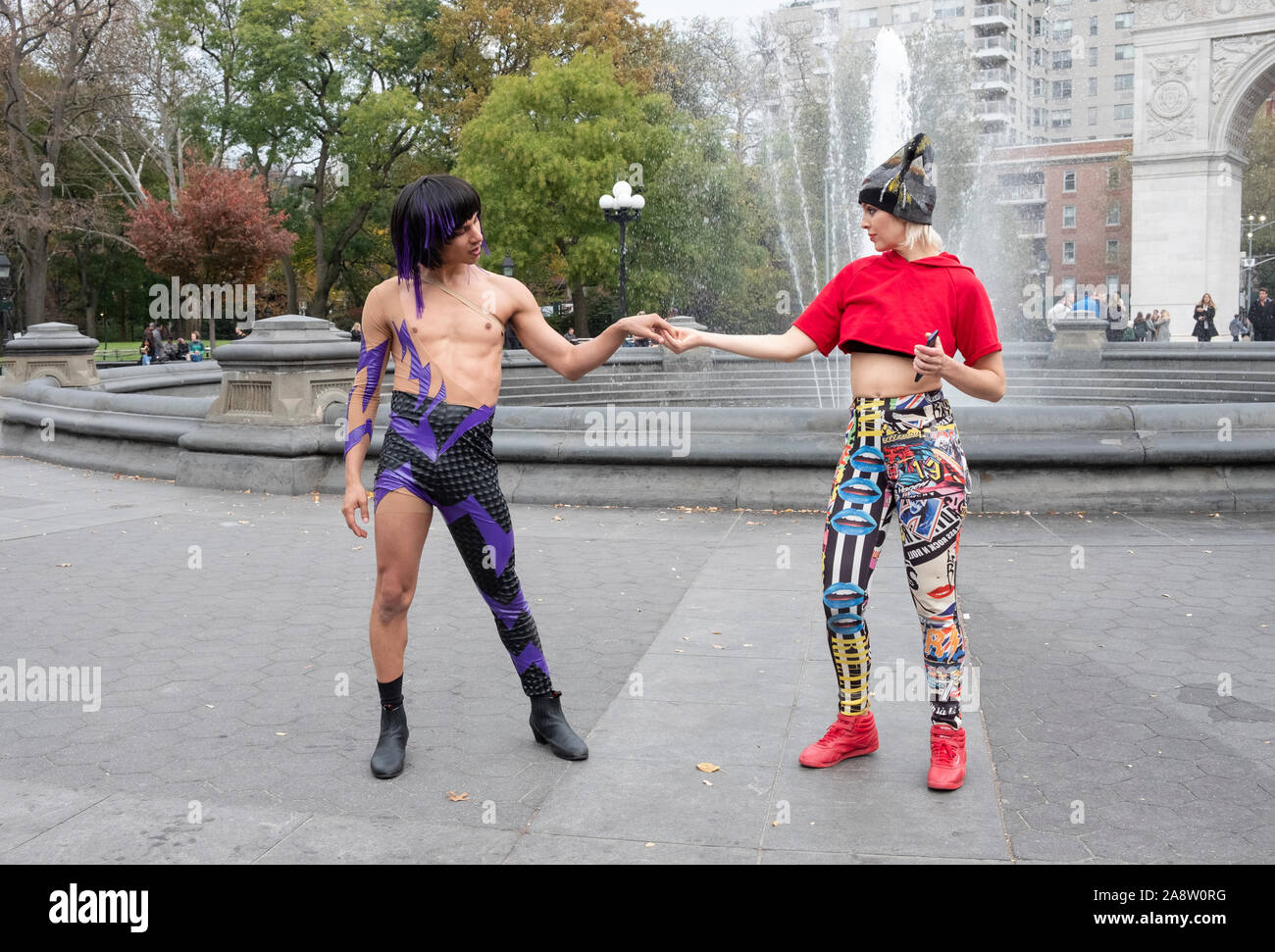 A male & female dancer perform for filmmaking students from Stony Brook  University. In Washington Square Park in Manhattan, New York City. Stock Photo