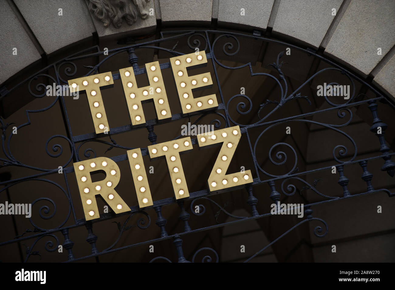 LONDON - MAY 6, 2012: Sign for the Ritz hangs on an arcade arch outside the five-star hotel, named after Swiss hotelier Cesar Ritz Stock Photo