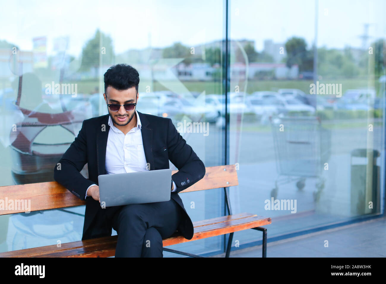 Cool guy arabic man uses laptop business center Stock Photo