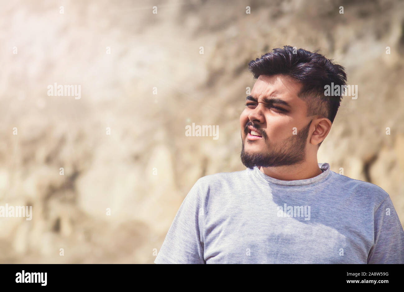 Closeup young Asian man face under summer heat wave Stock Photo