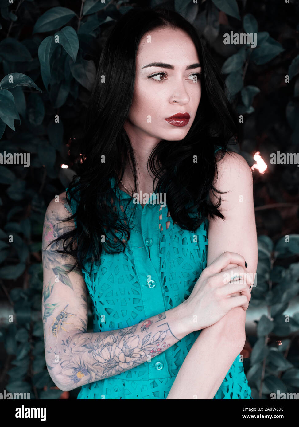 Beautiful young woman with tattooed arm Stock Photo