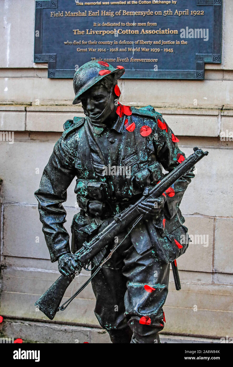 A statue of Field Marshal Earl Haig of Bemersyde is covered in poppy petals, as shoppers in Liverpool City Centre observe a silence to mark Armistice Day, the anniversary of the end of the First World War. Stock Photo