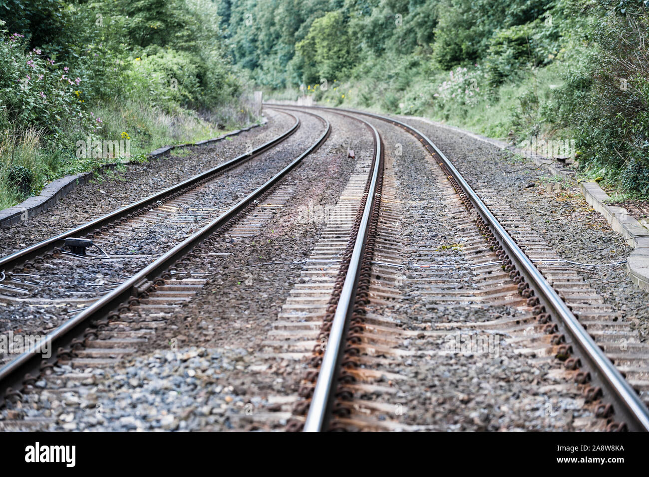Railway tracks approaching a bend Stock Photo