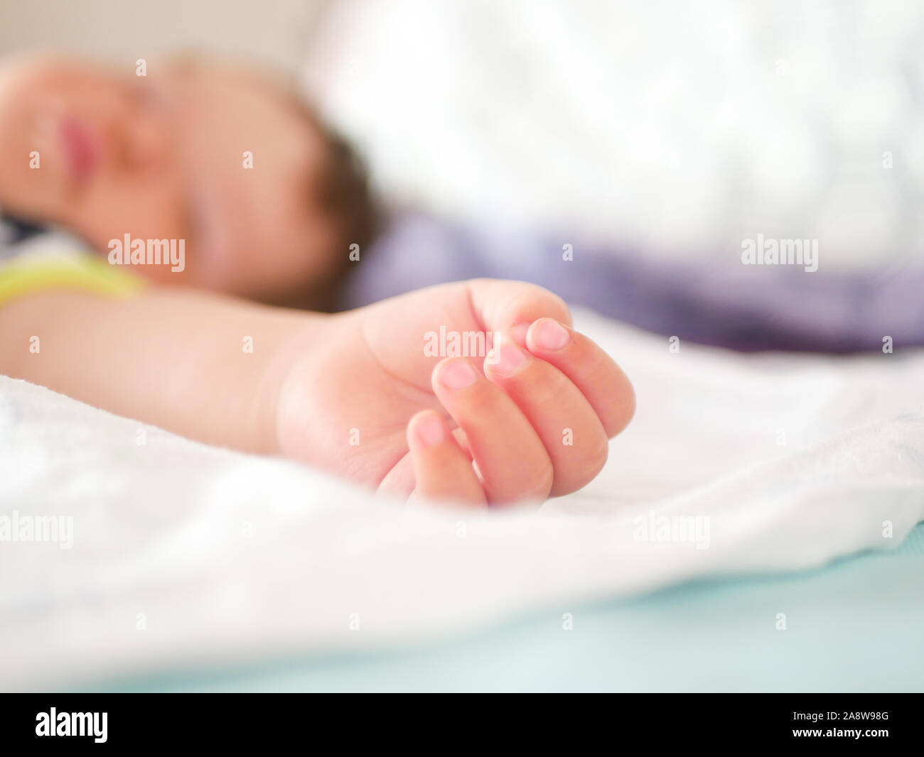 Childrens daytime sleep. Funny baby sleeping on the back of the bed at home. Children's day