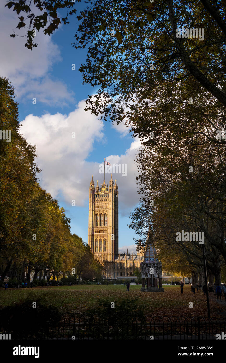 London Autumn Victoria Tower Palace of Westminster and Autumn Leaves reflected in Victoria Tower Gardens. 8 Nov 2019 The Victoria Tower is a square to Stock Photo