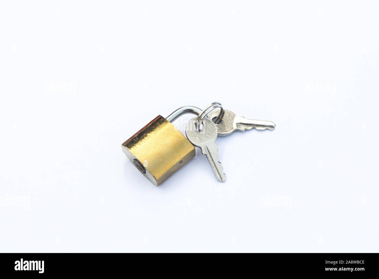 keys lies next to a padlock isolate on a white background Stock Photo