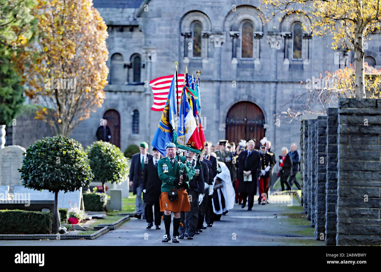 Flagbearers carrying flags of allied nations who took part in World War One during a service at Glasnevin cemetery, Dublin, to mark Armistice Day, the anniversary of the end of the First World War. Stock Photo