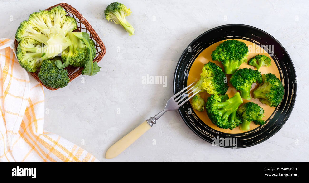 Boiled broccoli on a plate on a light background. Healthy eating concept. Sports diet. Proper