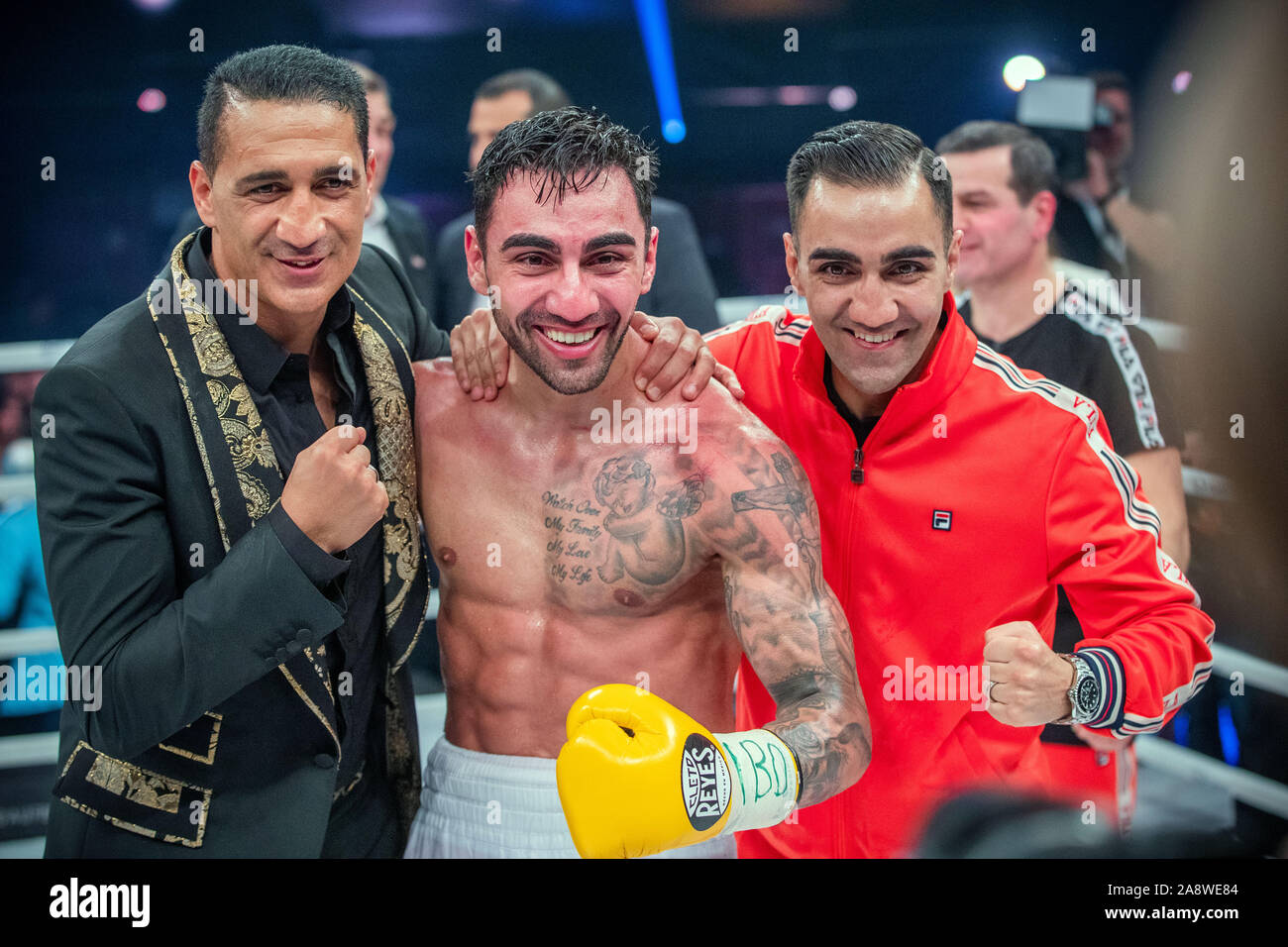 Hamburg, Germany. 10th Nov, 2019. Boxing: Artem Harutyunyan (Germany, M)  cheers next to his brother Robert Harutyunyan (r) and Ismail Özen-Otto (l),  promoter of Universum Box Promotion, after his victory in the