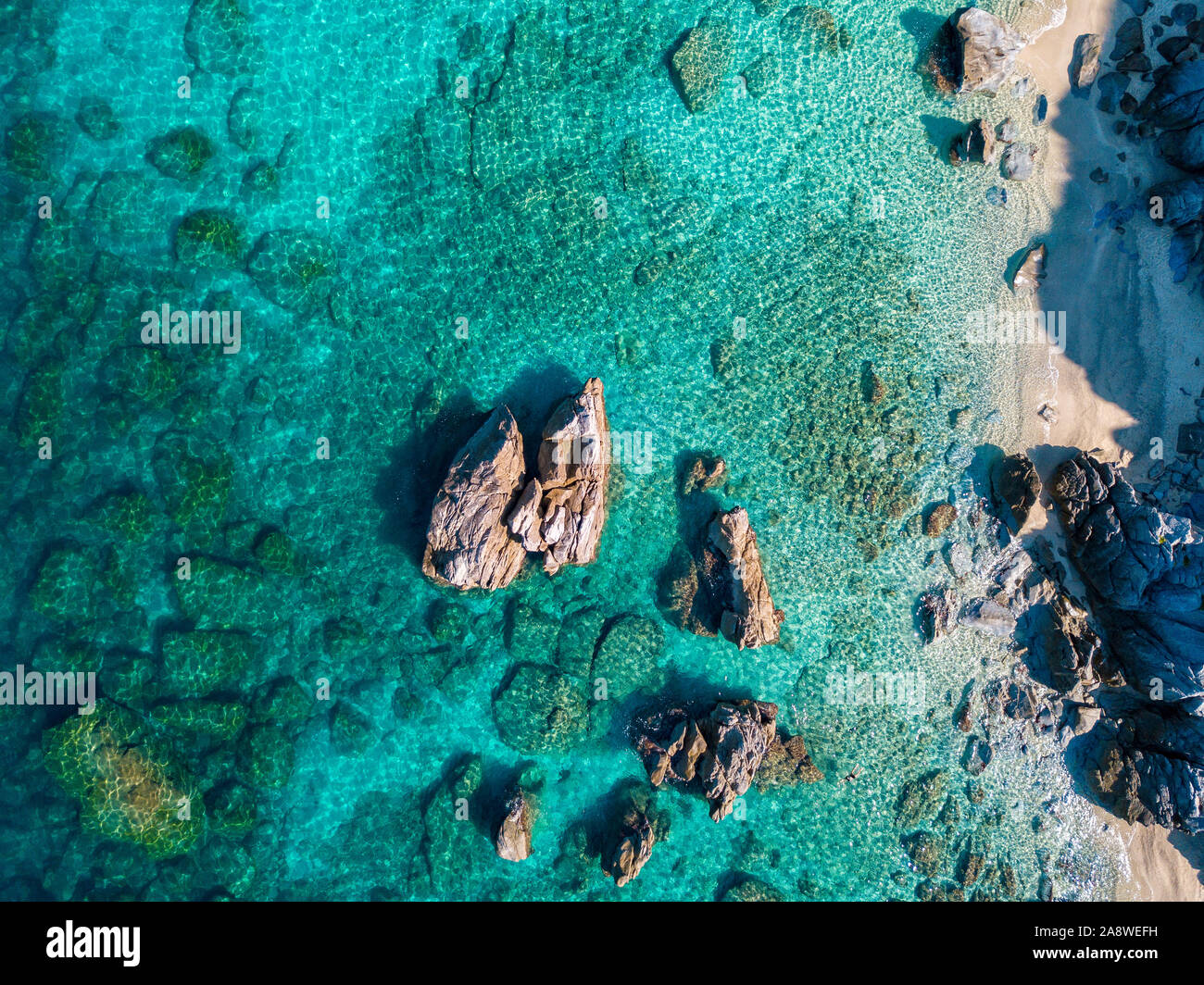 Aerial view of Tropea beach, crystal clear water and rocks that appear ...
