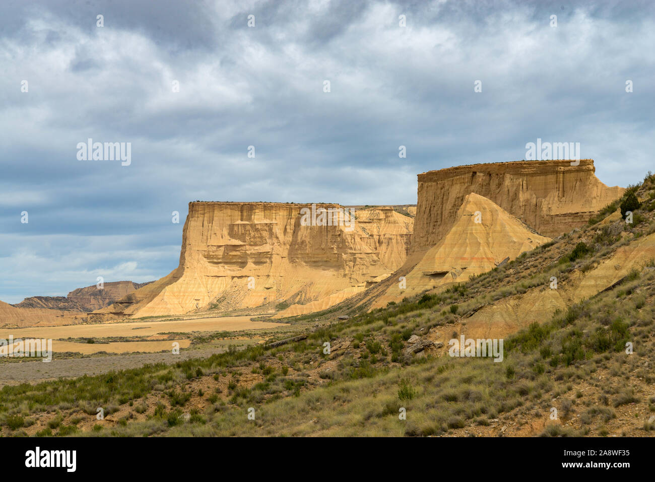 Flat-topped mountains with steep escarpments above a plain in the Spanish desert Bardenas Reales Stock Photo