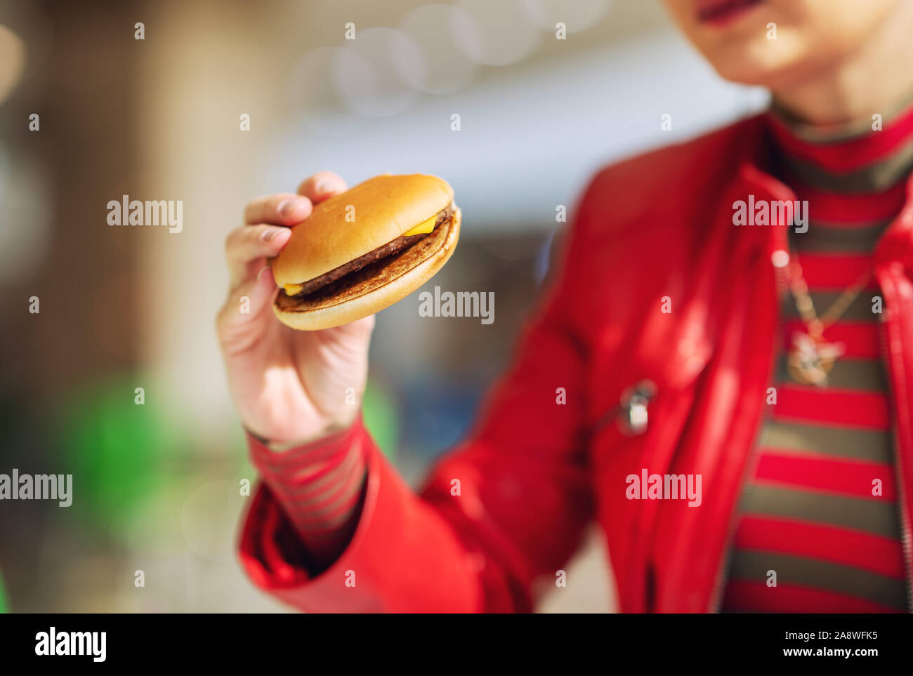 Young woman eat fast food in her break. Stock Photo