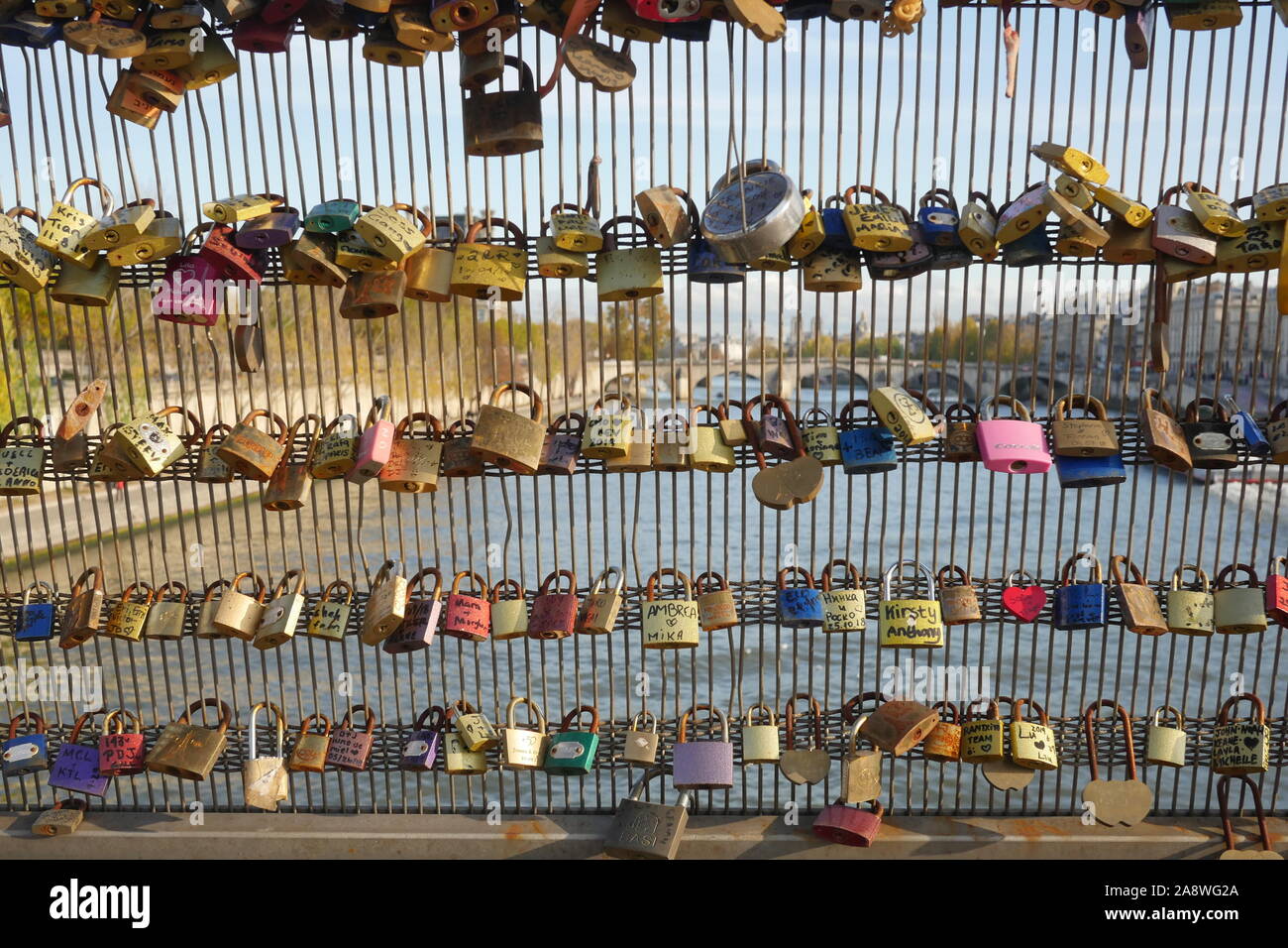 Love locks hanging on the Pont d'Arts in Paris.The weight of these locks is damaging the bridges in the area. Stock Photo