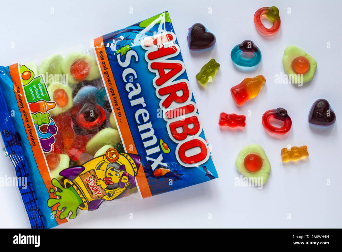 Packet of Haribo Scaremix sweets candy candies opened with contents spilled spilt set on white background Stock Photo