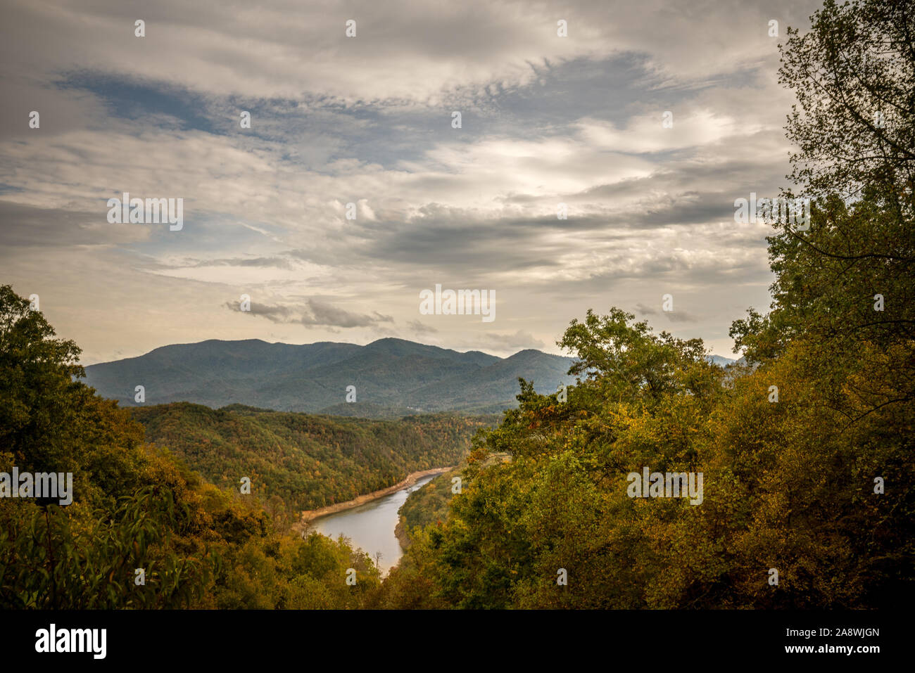 View of lake and mountains with cloudy sky. Stock Photo