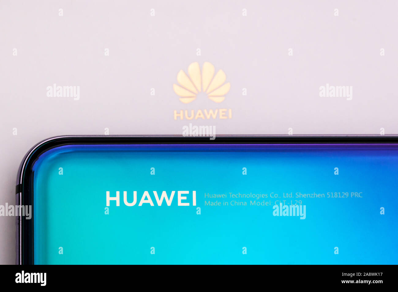 Close up of a Huawei smartphone on its white box with Huawei logo Stock Photo