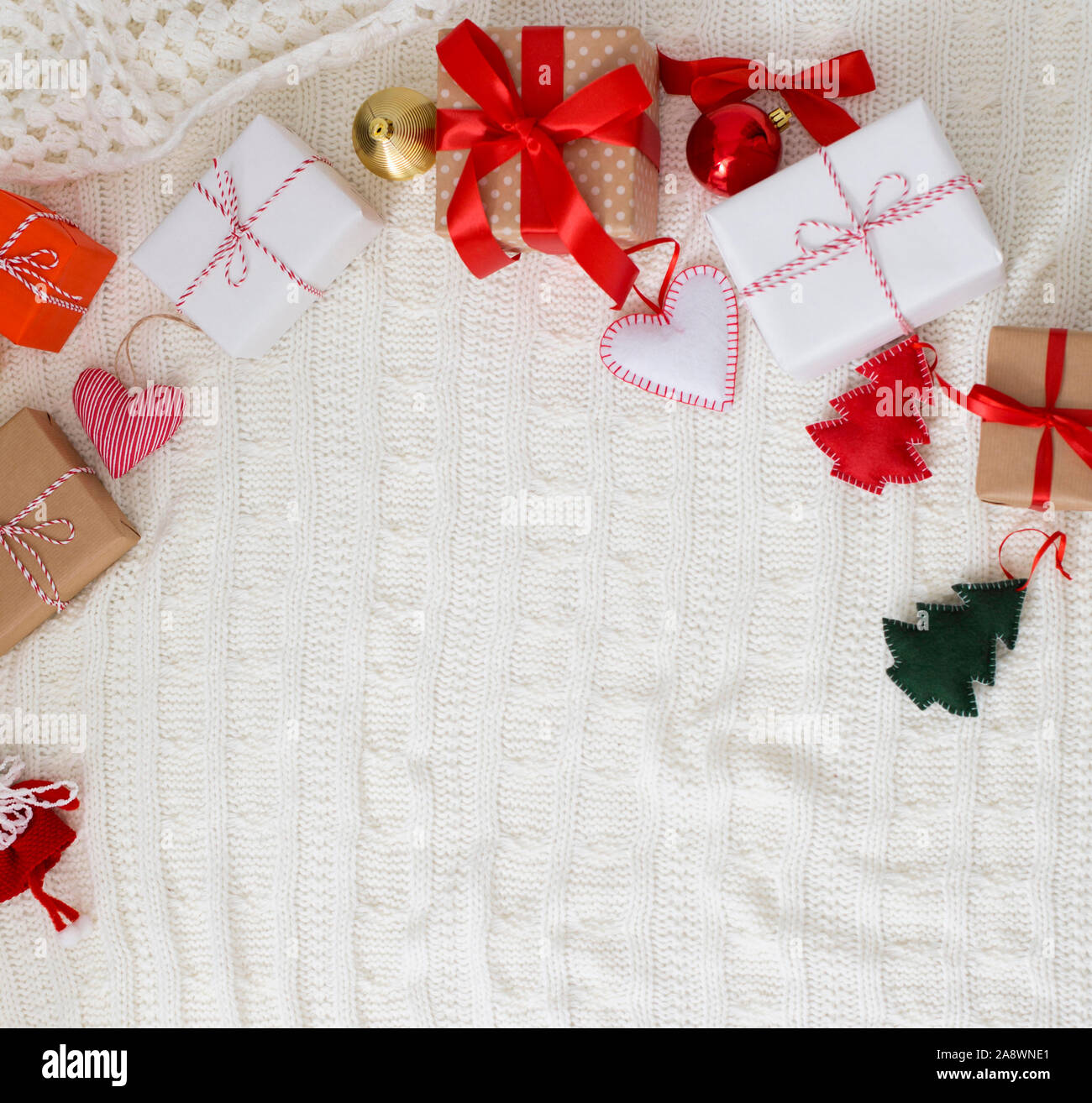 Christmas gift boxes on woolen duvet with decorations Stock Photo