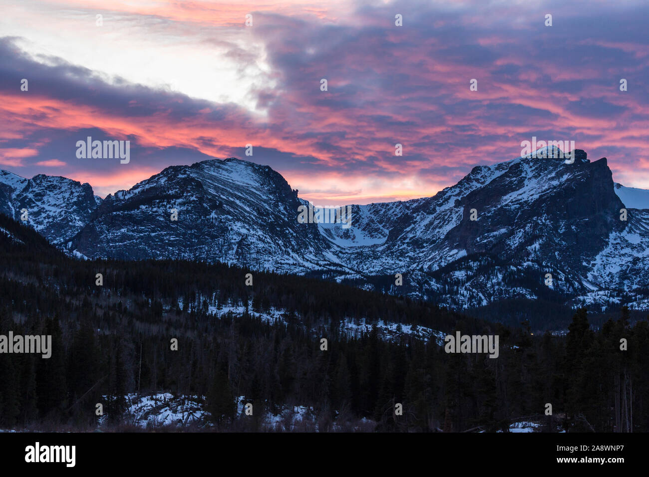A beautiful sunset over the mountains overlooking Sprague Lake in Rocky Mountain National Park in Colorado. Stock Photo