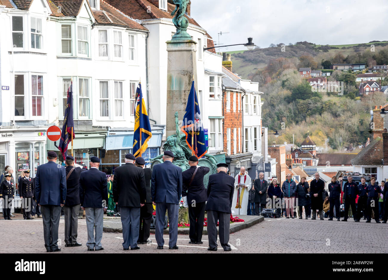 Lewes, East Sussex, UK. 11th November, 2019. As people gathered to remember the war dead and observe a minutes silence a local man disrupted the proceeding by spitting towards a member of the Church as he performed the readings in front of the towns War Memorial. Sussex police officers spoke with the individual concerned. Credit: Alan Fraser/Alamy Live News Stock Photo