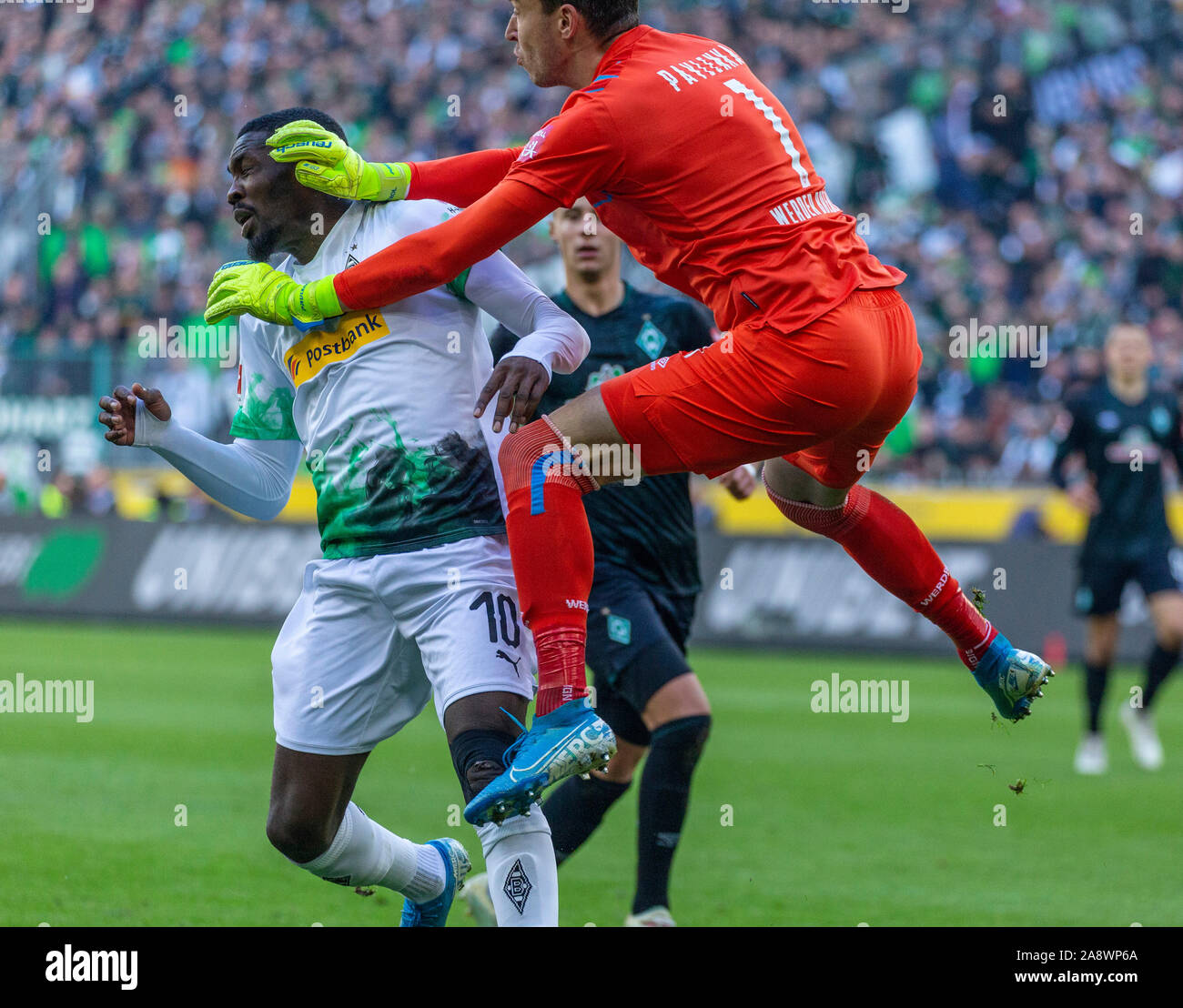 sports, football, Bundesliga, 2019/2020, Borussia Moenchengladbach vs. SV Werder Bremen 3-1, Stadium Borussia Park, scene of the match before the 2-0 goal by Patrick Herrmann (MG) not pictured, keeper Jiri Pavlenka (SVW) right and Marcus Thuram (MG), behind Marco Friedl (SVW), DFL REGULATIONS PROHIBIT ANY USE OF PHOTOGRAPHS AS IMAGE SEQUENCES AND/OR QUASI-VIDEO Stock Photo