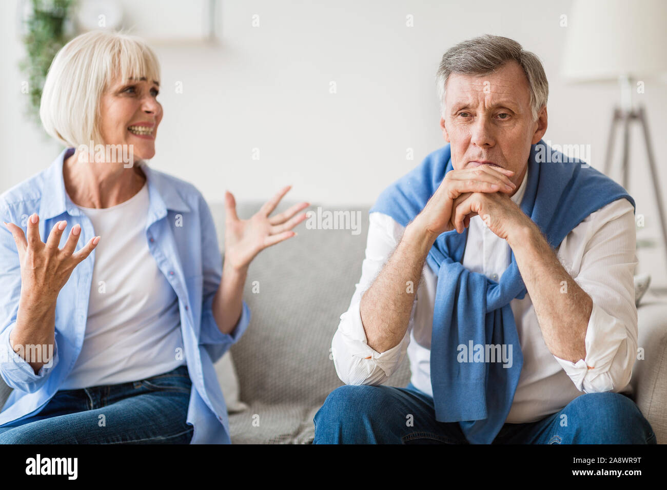 Abusive relationship. Angry woman shouting at husband Stock Photo
