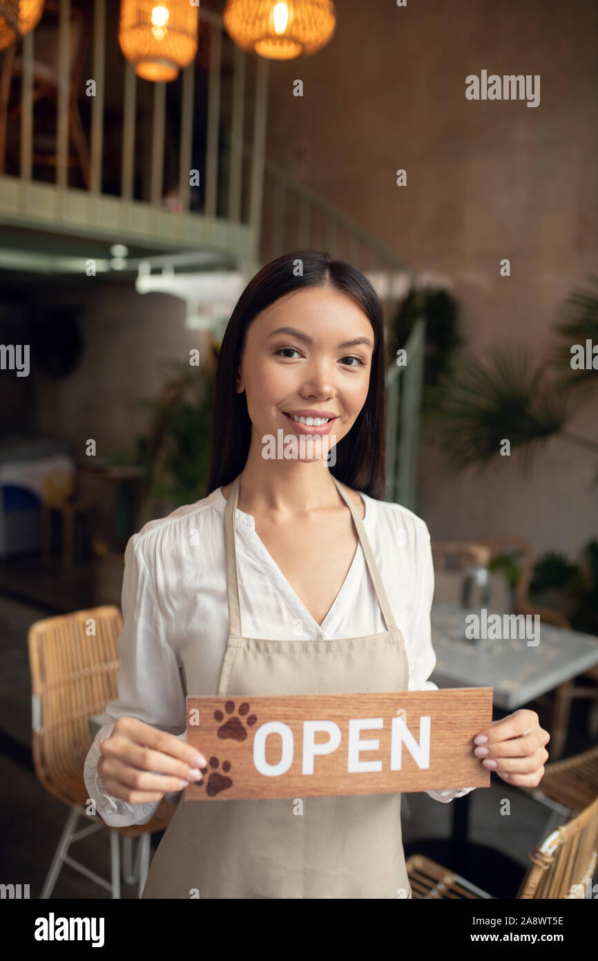 Beautiful dark-haired woman opening her own cafeteria Stock Photo
