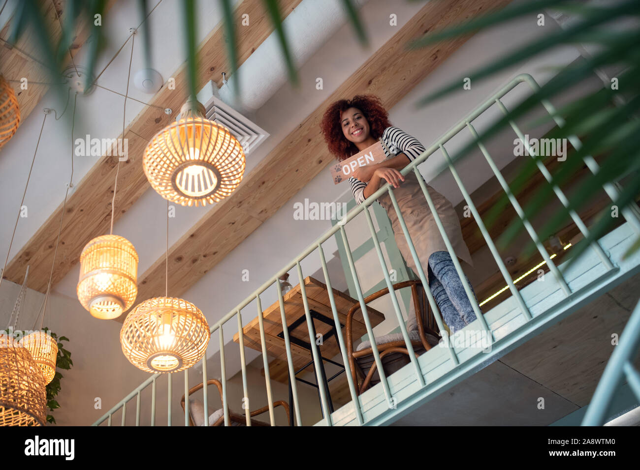Curly red-haired entrepreneur opening little coffee shop Stock Photo