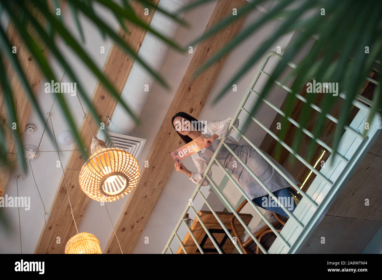 Businesswoman standing on the second floor of her cafeteria Stock Photo