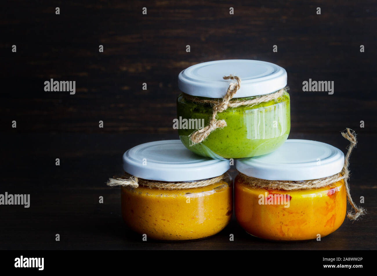 Several types of typical Canary Islands sauces in glass jar: Mojo picon, mojo verde  made and almogrote are popular souvenirs of the fun holiday exper Stock Photo