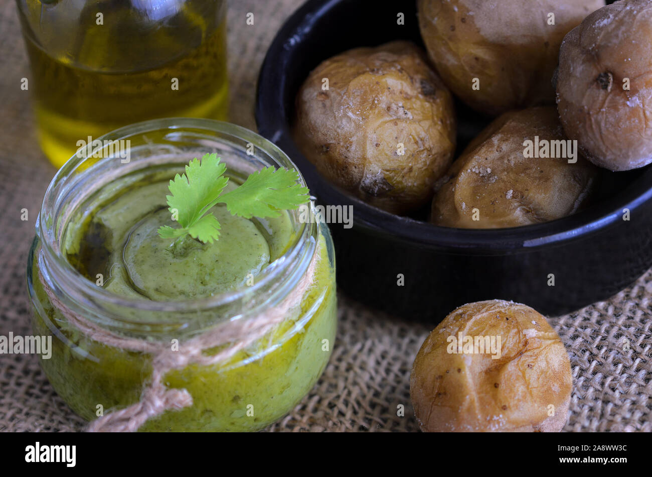 Typical Canary Islands sauce, mojo verde, made of parsley, garlic, sal and  the cumin, is usually eaten with meat. Stock Photo