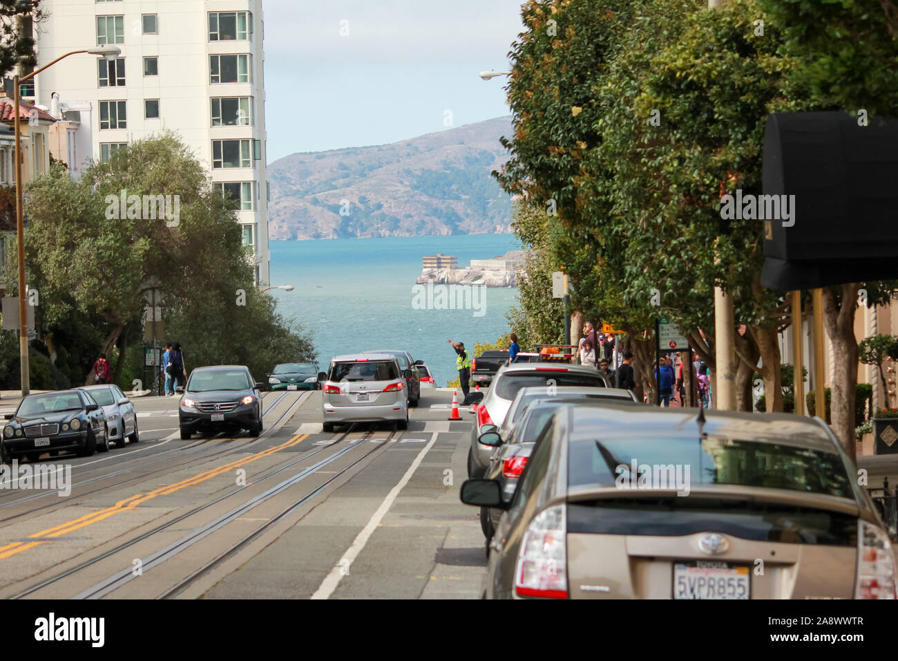 San Francisco, California / USA - September 20 2014: Scenic view of one of the downhill street in San Francisco city with background of the bay Stock Photo