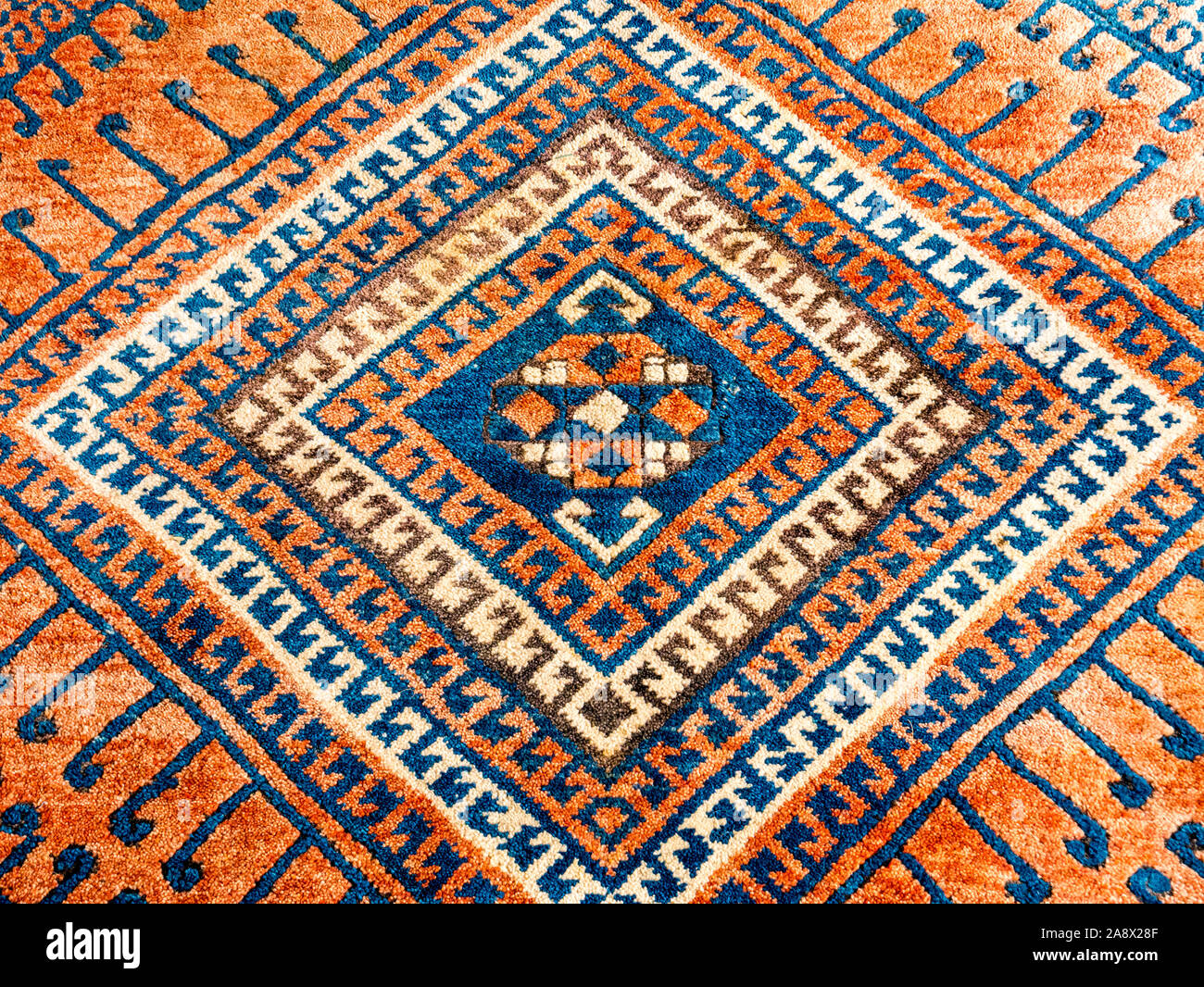 Square geometric pattern, detail of oriental persian carpet in mainly red and blue Stock Photo