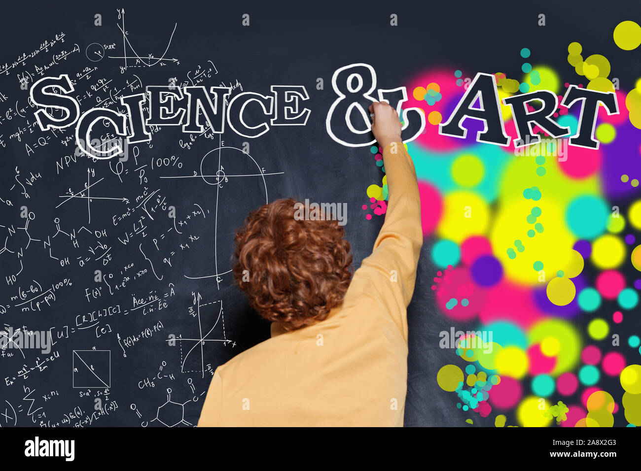 Child boy writing science and arts inscription on chalkboard Stock Photo