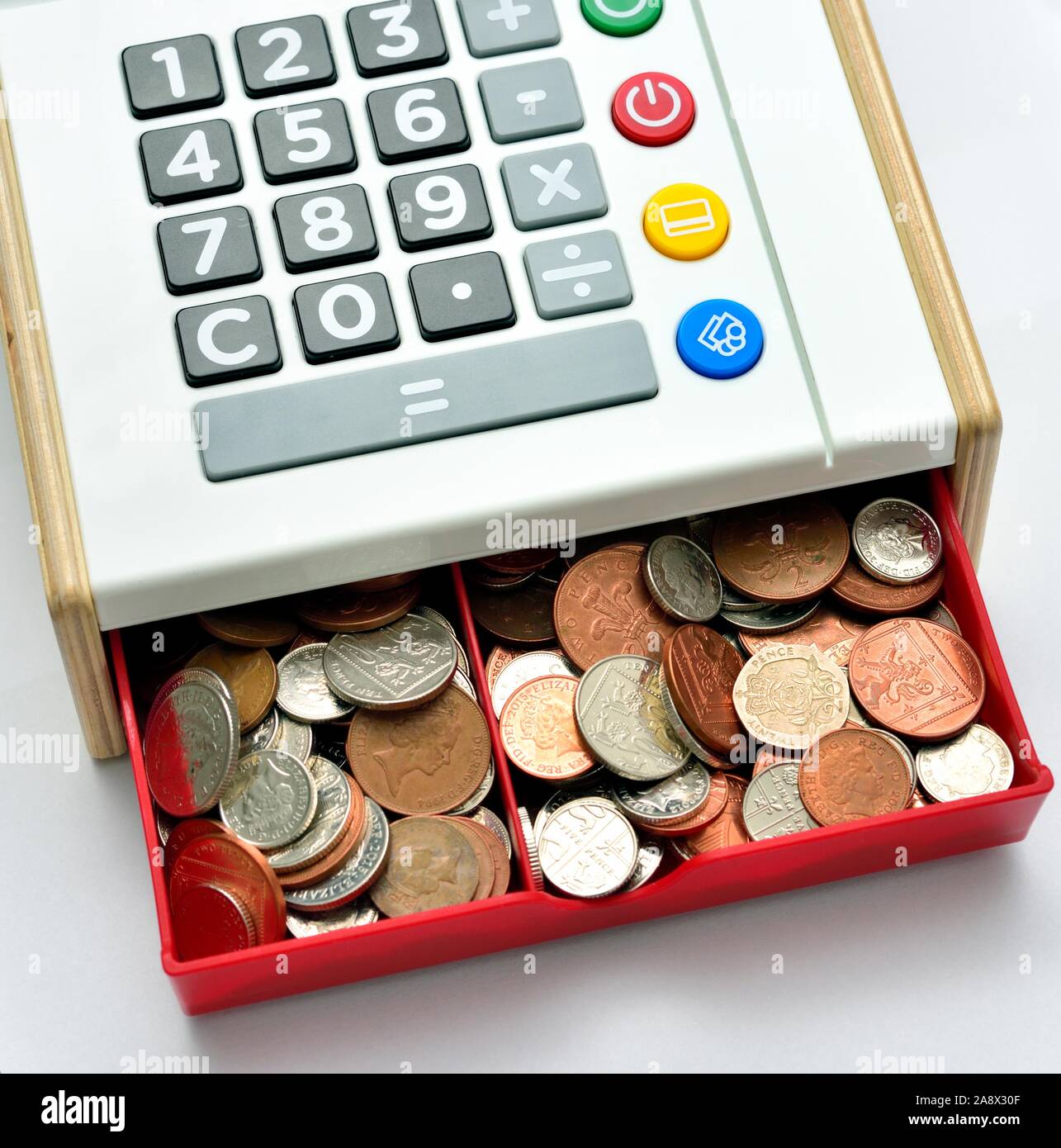 Children's play cash register cash till,with drawer full of small change Stock Photo